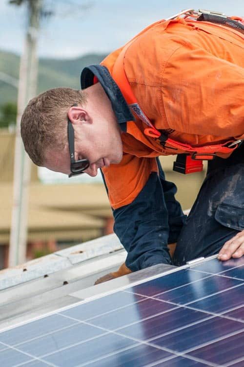 A Man Checking the Solar Panel — Solar Power Services in Brisbane, QLD